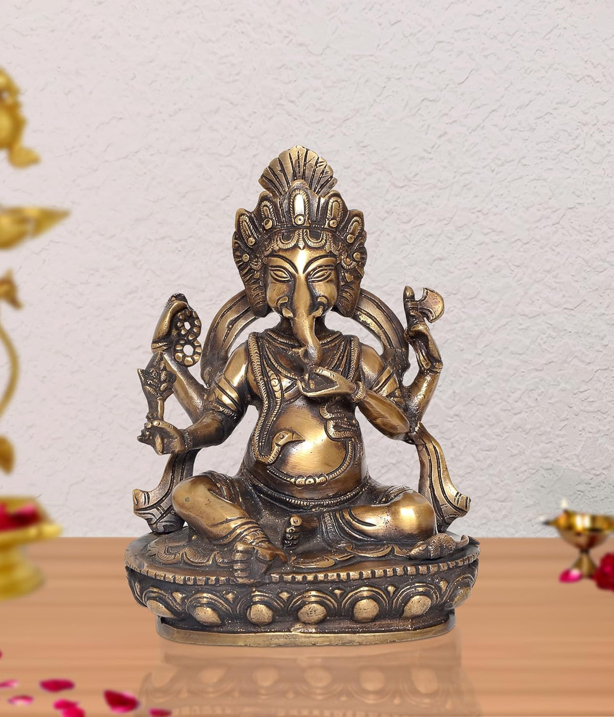 Brass Lord Ganesha idol, seated with multiple arms, ornate details, 8 inch height