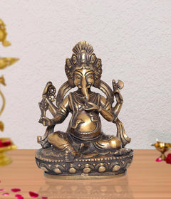 Brass Lord Ganesha idol, seated with multiple arms, ornate details, 8 inch height