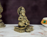 Kuber Bhagwan bronze murti, angled view showing ornate headdress and seated hands
