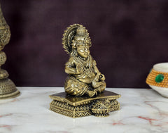 Kuber Bhagwan bronze murti, angled view showing ornate headdress and seated hands
