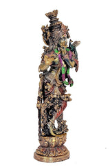 Krishna statue three-quarter view, green and red cloth accents, intricate headdress