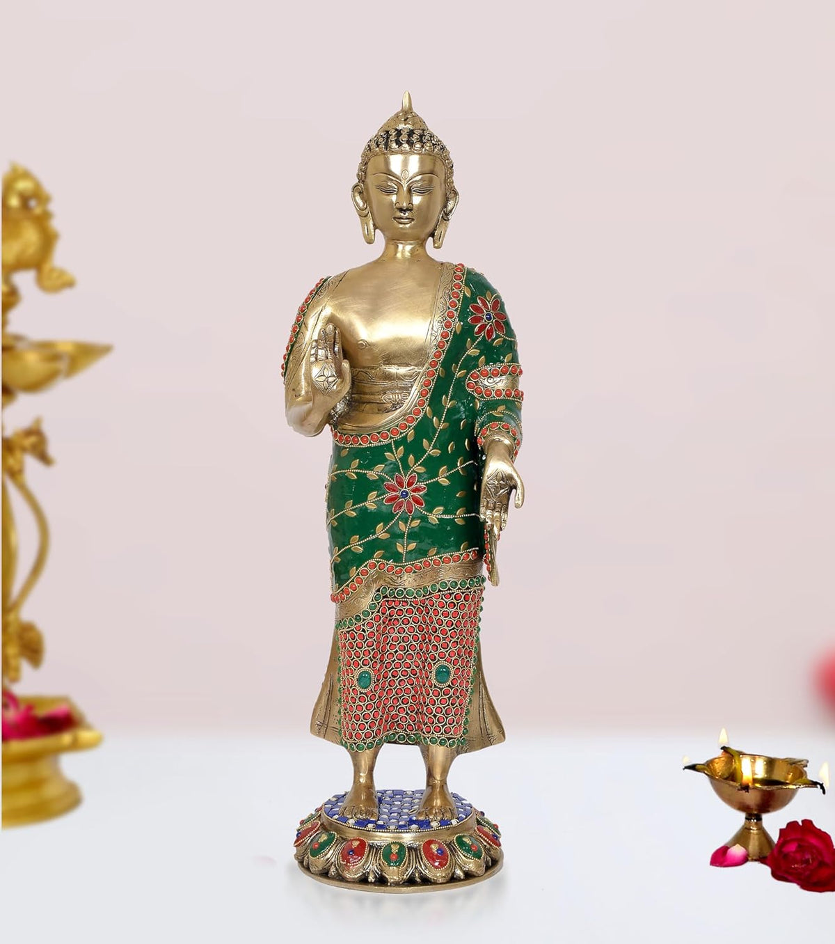 Standing Buddha statue, brass gold finish, green robe with red floral trim, raised blessing hand