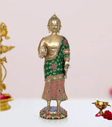 Standing Buddha statue, brass gold finish, green robe with red floral trim, raised blessing hand