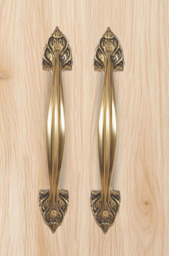 Golden brass door handles pair with ornate top fleur-de-lis escutcheons