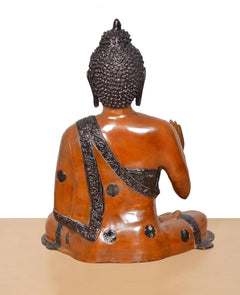 Rear view brass Buddha idol, seated cross-legged with draped robe and dot details