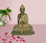 Brass Buddha statue seated on ornate lotus base, green and gold detailing