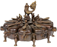 Brass peacock ritual box: peacock finial with lid, circular petal shapes, side view