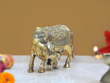 Brass cow with calf statue, close side view, ornate head and leg detailing