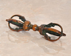 Small brass Tibetan dorje with eight-pronged detail, multicolor aged finish