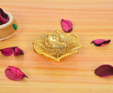 Golden metal oil diya lamp, leaf-shaped base with flame; height 1 inch