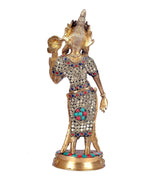 Brass Tara Devi idol, back view, painted medallion and blue-red jewelry trim
