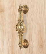Ornate brass door handle, golden finish, full handle with two round plates
