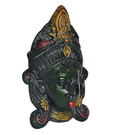 Brass Durga face idol mask side view, dark green face with golden crown, red lips