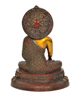 Back view of meditating Buddha statue with ornate circular halo design