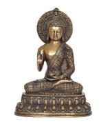 Seated meditating Buddha idol in brass with dhyan mudra hand gesture, ornate halo