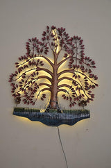 LED lit iron tree wall art with pink leaves, glowing branches, and blue scalloped base