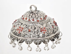 Silver metal chatta with engraved floral scrollwork, red beads, and bell tassels