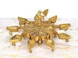 Top view of golden brass kumkum box with peacock finial and 9 compartments