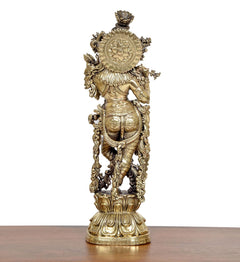 Brass Lord Krishna idol rear view with detailed back ornamentation and pedestal base