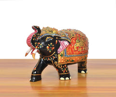 Wooden elephant showpiece, side profile with raised painted trunk, floral motifs and gold trim