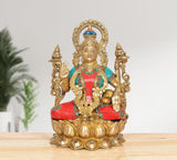 Lakshmi brass idol front view with ornate crown, four arms, multicolor detailing