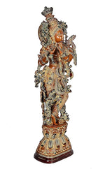Back/side view of brass Lord Krishna figurine, brown with ornate layered decoration