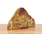 Brass Ganesha idol angled view with elephants and decorative gold detailing