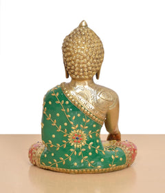 Brass Buddha statue back view, seated pose with green robe and floral motifs