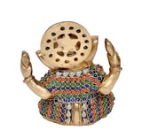 Brass Ganesh idol from behind with round back plate, hole design, and gem-inlay robe