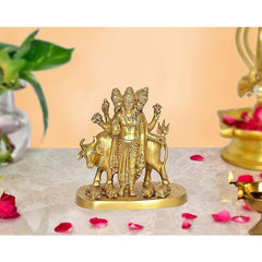 Brass Trimurti idol with auspicious cow and Shiva, three faces on round base