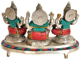 Back view of brass Ganesh-Lakshmi-Saraswati idol trio on circular pedestal