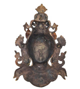 Back of Tara wall hanging mask, dark bronze relief with dangling loops