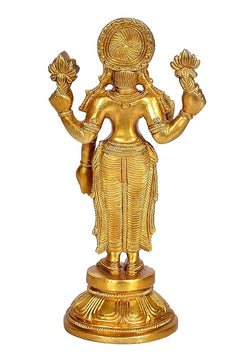 Rear view golden brass Lakshmi idol standing on ornate round pedestal