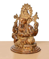 Brass Ganesha statue, brown, side angle with trident-like hand and ornaments