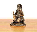 Brass Hanuman JI statue seated, profile view with raised blessing hand on decorative pedestal