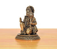 Brass Hanuman JI statue seated, profile view with raised blessing hand on decorative pedestal
