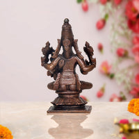 Copper Vishnu avatar rear view, seated multi-armed idol with tall headpiece
