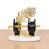 Three-quarter view: black resin Krishna hands with gold flute and ornate gold halo