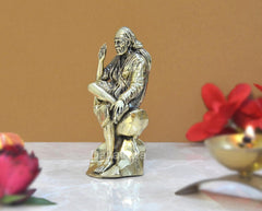 Brass Shirdi Sai Baba statue, side angle, seated with hands resting