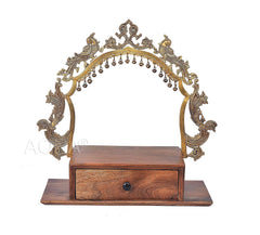 Wooden base mandir with brass arched frame and hanging bell trim, drawer front