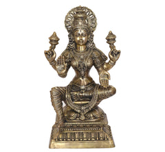 Lakshmi goddess statue, four arms raised, detailed dress and halo, brass tone