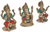 Lakshmi, Ganesha, Saraswati brass idols, silver tone, teal-and-red detailing, raised arms