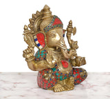 Brass Ganpati Bappa murti three-quarter view, multicolor patterned clothing and crown