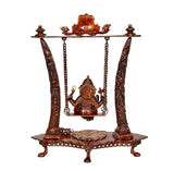 Front view of brass Ganesha swing showpiece with round patterned base