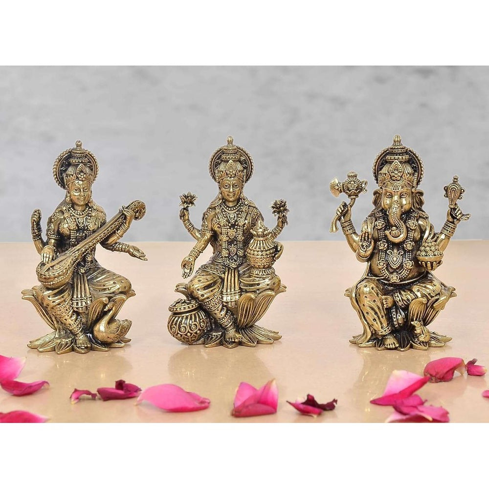 Brass Lakshmi, Saraswati and Ganesha idol set on raised lotus bases, 4 in height.