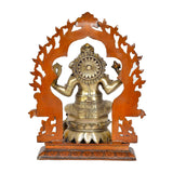 Brass Ganesha idol from behind, seated with tall arched frame and round halo