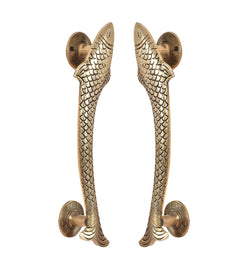 Golden brass fish door handles pair, angled view with round mounts and fin details