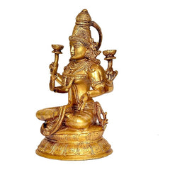Brass Lakshmi statue angled view, seated on lotus with raised holding arms