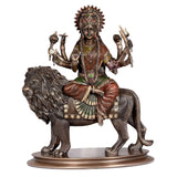 Bonded bronze Durga seated on lion, side view; detailed face, hands, and mane