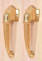Gold-tone brass Ganesha face door handles with decorative chevron grip and round base